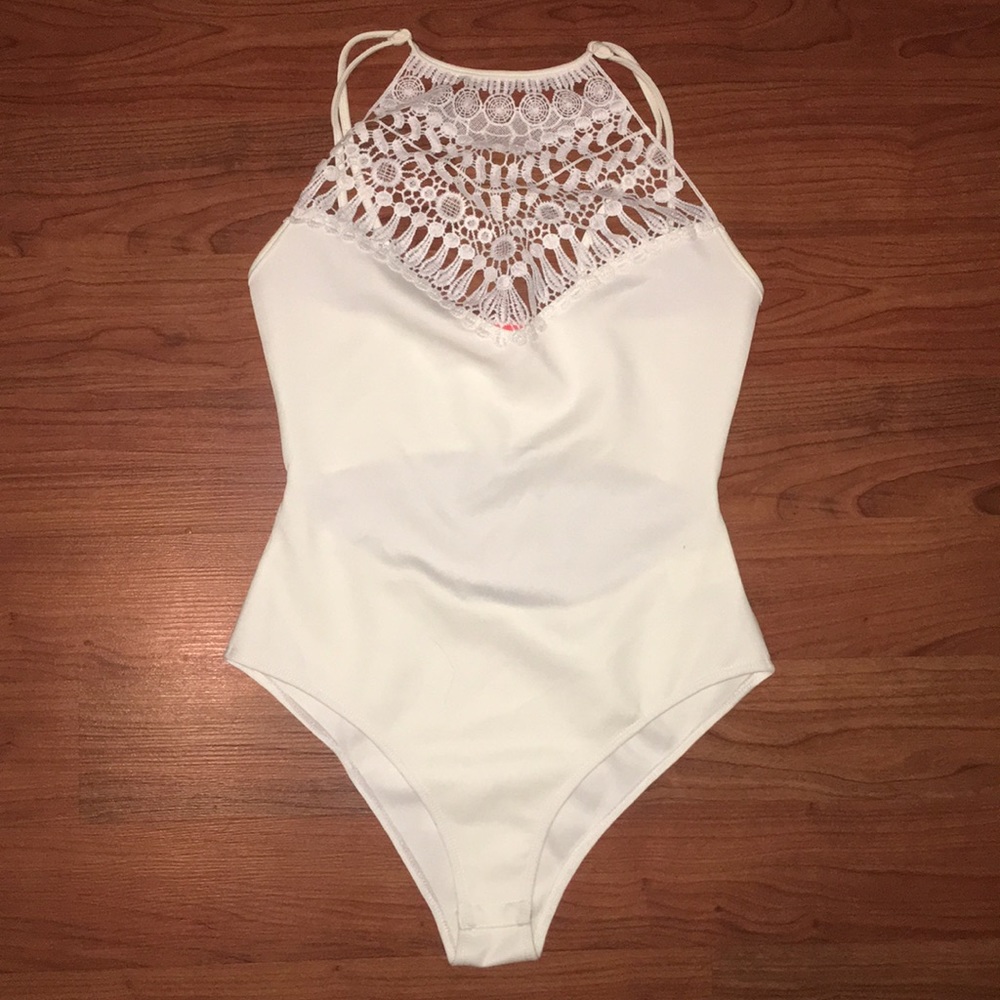 White Banjul lacy body suit.Unworn without tags